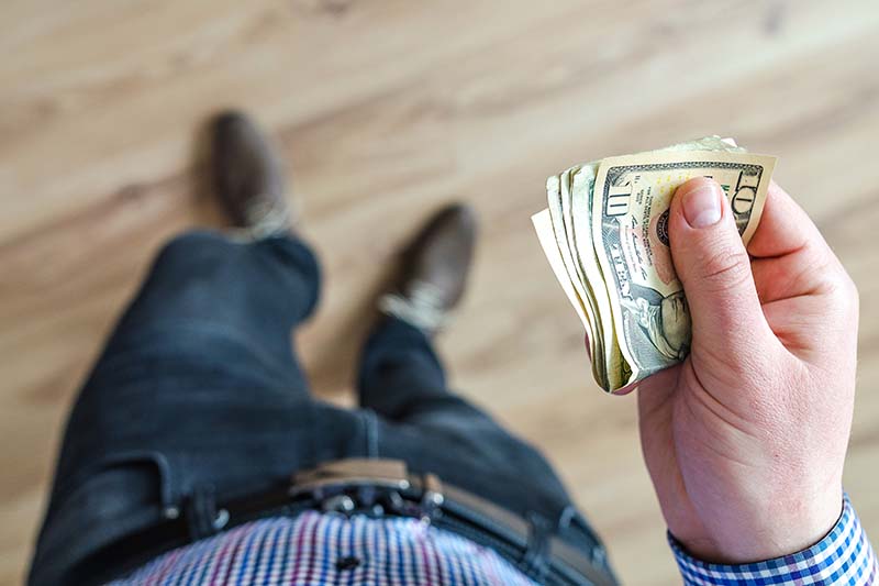 Man holding cash interior